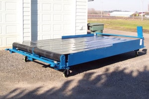 Truck Conveyor - This unit is designed for easy loading within a cargo truck. Simply load items into the truck with a forklift, then use the truck conveyor to move them easily to the front of the truck. It utilizes electric eye technology.